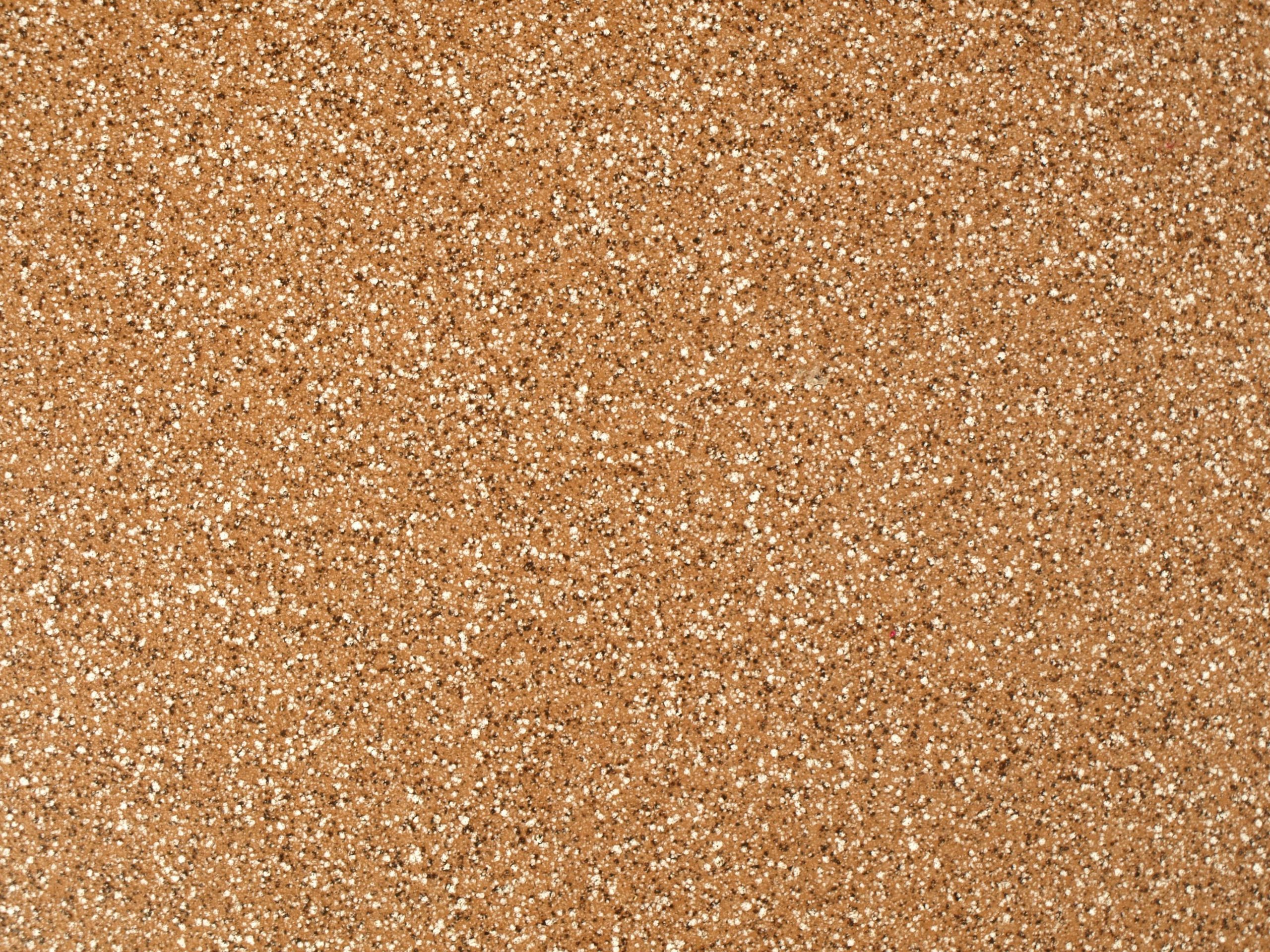 Close-up view of a granular sandstone surface texture, ideal for backgrounds.